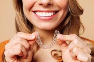 Woman holding clear aligner